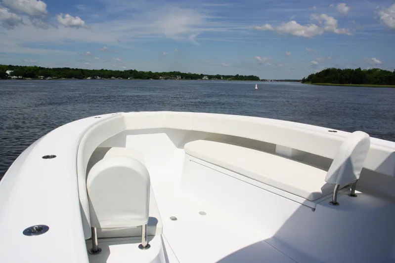  Yacht Photos Pics 2019 Bahama 41 boat with white seating, cruising on a calm river under a blue sky.