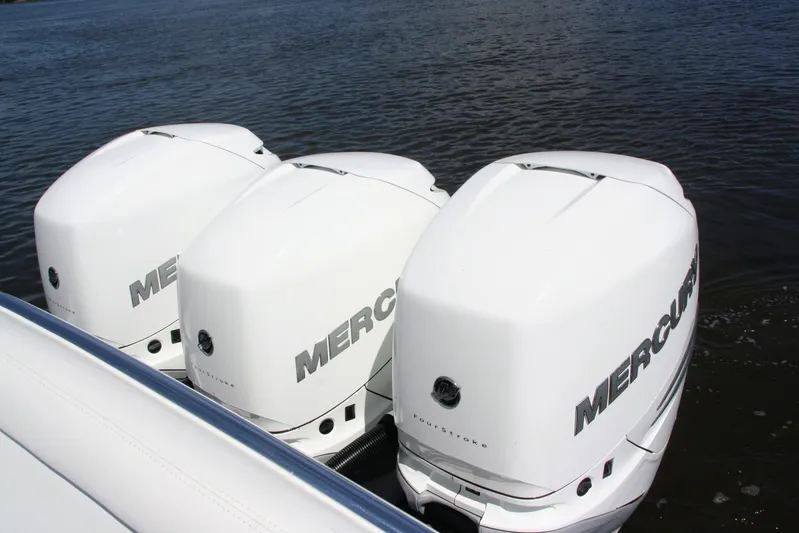  Yacht Photos Pics Triple Mercury outboard engines on a 2019 Bahama 41 boat in water.