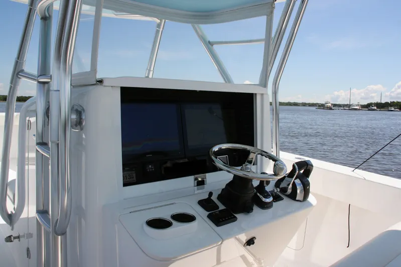  Yacht Photos Pics 2019 Bahama 41 boat helm with steering wheel and navigation screens on a sunny day.