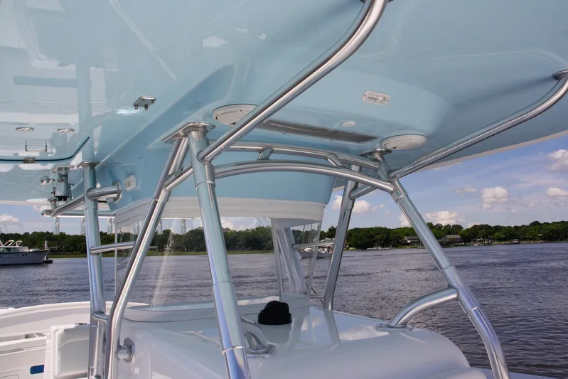  Yacht Photos Pics 2019 Bahama 41 boat with sleek blue canopy and stainless steel supports on a calm waterway.