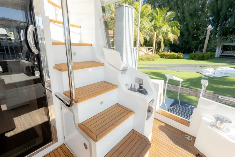 Rho Boat Yacht Photos Pics Staircase on 2021 Azimut Fly 72 yacht with teak steps and stainless steel handrail.