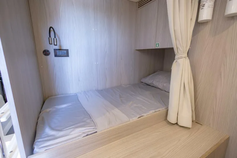 Rho Boat Yacht Photos Pics Cozy cabin bed in 2021 Azimut Fly 72 yacht, featuring light wood paneling.