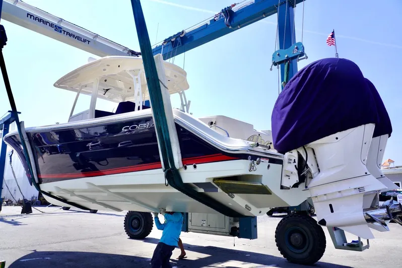  Yacht Photos Pics 2020 Cobia 350 Center Console boat being lifted by a marine travel lift.
