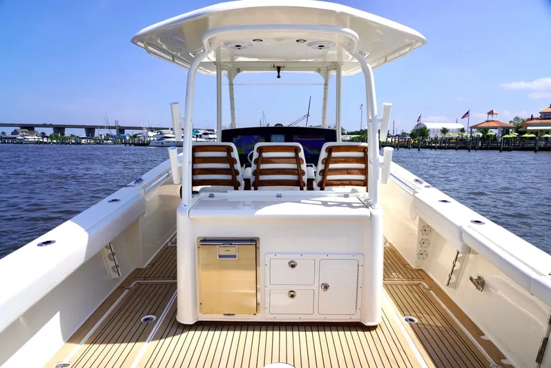  Yacht Photos Pics 2020 Cobia 350 Center Console boat with spacious deck and seating, docked by the waterfront.