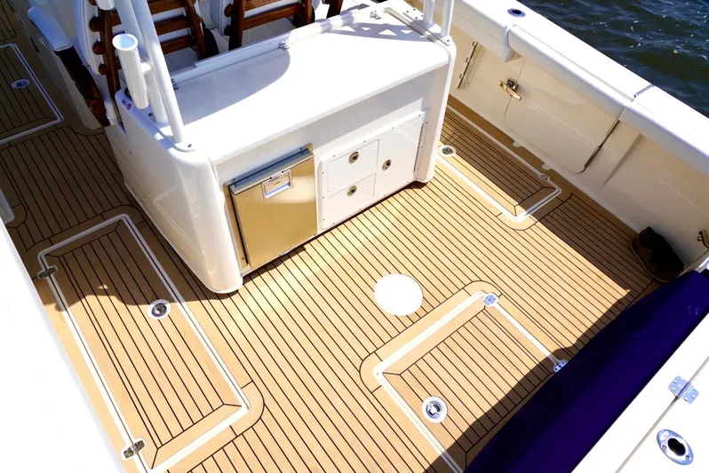  Yacht Photos Pics 2020 Cobia 350 Center Console boat deck with storage compartments and seating.