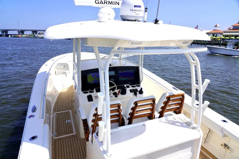  Yacht Photos Pics 2020 Cobia 350 Center Console boat with advanced navigation system on calm waters.