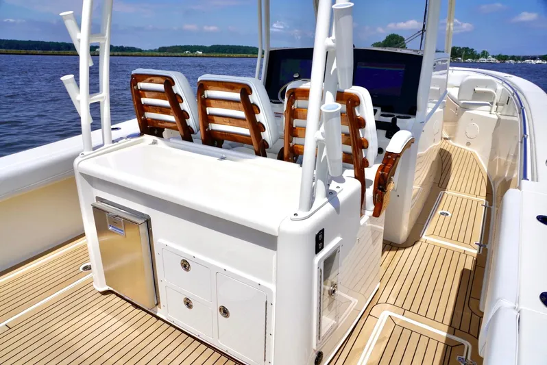  Yacht Photos Pics 2020 Cobia 350 Center Console boat with sleek deck and seating, cruising on calm waters.