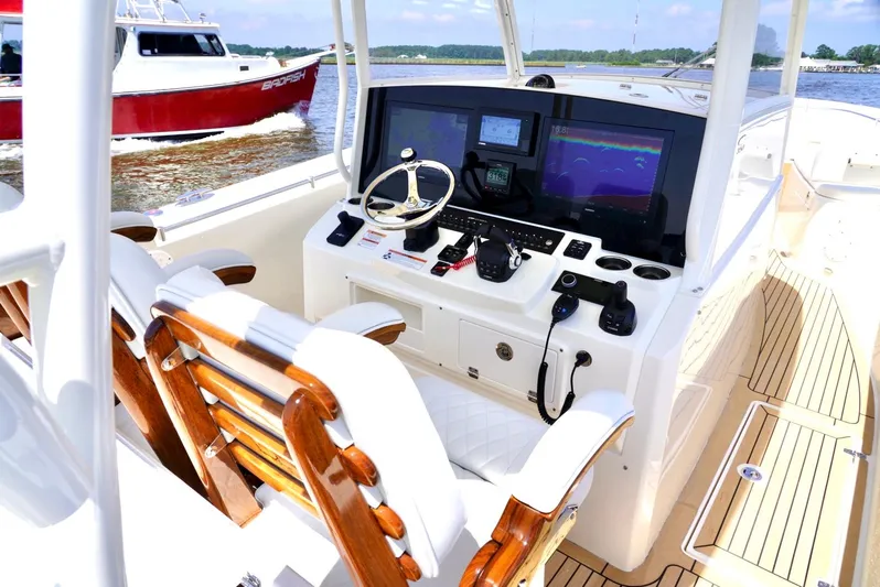  Yacht Photos Pics 2020 Cobia 350 Center Console boat interior with advanced navigation system and wooden seating.