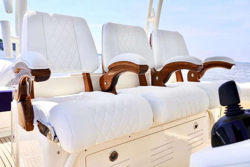  Yacht Photos Pics Luxurious seating on 2020 Cobia 350 Center Console boat with white upholstery and wooden accents.