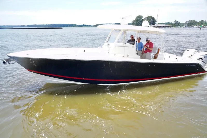  Yacht Photos Pics 2020 Cobia 350 Center Console boat cruising on a calm lake with passengers onboard.