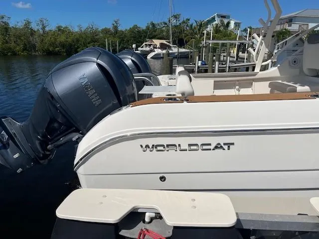  Yacht Photos Pics 2022 World Cat 296 DC boat with Yamaha engines docked by the water.