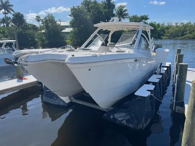  Yacht Photos Pics 2022 World Cat 296 DC boat docked by a scenic waterfront.
