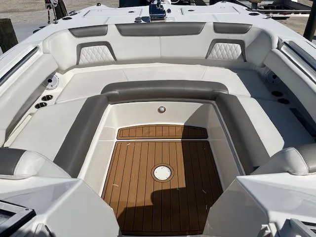  Yacht Photos Pics 2022 World Cat 296 DC boat interior with cushioned seating and teak flooring.