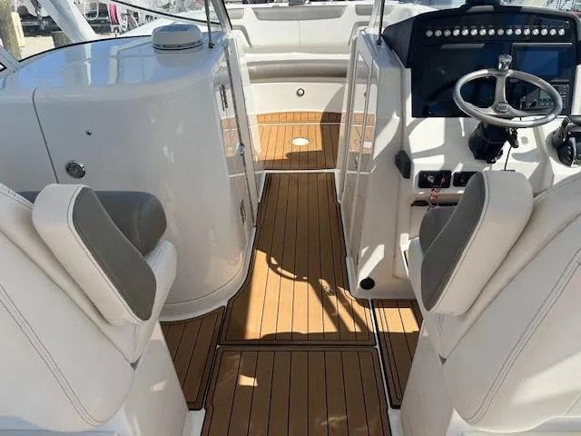  Yacht Photos Pics 2022 World Cat 296 DC boat interior with teak flooring and modern helm controls.