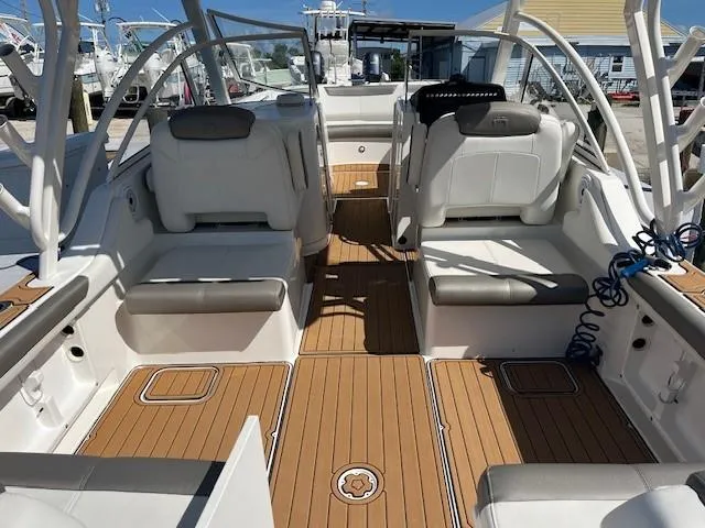  Yacht Photos Pics 2022 World Cat 296 DC boat interior with cushioned seating and teak flooring.