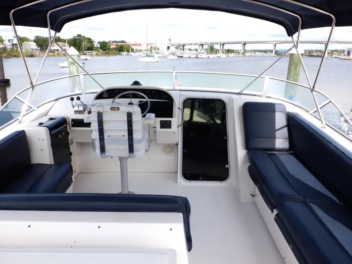 Epic Yacht Photos Pics 1998 Bayliner 4788 Pilothouse Motoryacht interior with helm, seating, and waterfront view.