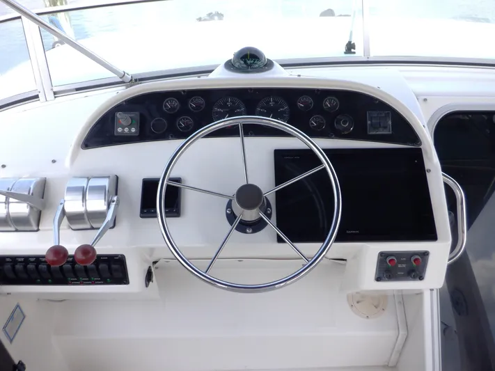Epic Yacht Photos Pics 1998 Bayliner 4788 Pilothouse Motoryacht helm with steering wheel and control panel.