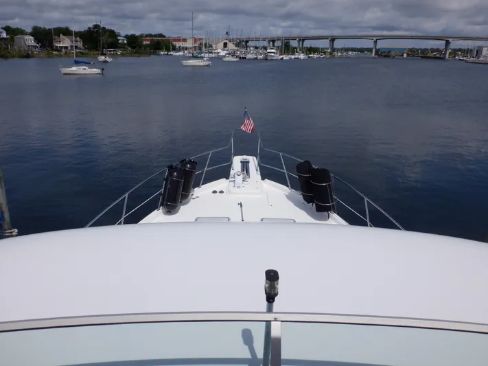 Epic Yacht Photos Pics 1998 Bayliner 4788 Pilothouse Motoryacht on calm water with bridge and marina view.