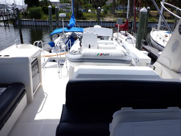 Epic Yacht Photos Pics 1998 Bayliner 4788 Pilothouse Motoryacht deck with seating and inflatable boat.
