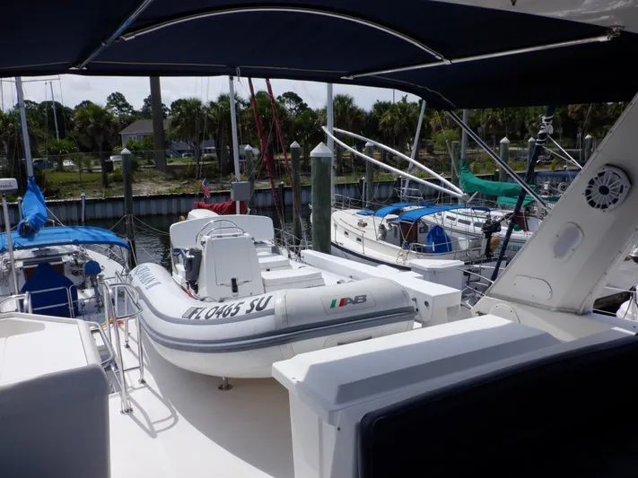 Epic Yacht Photos Pics 1998 Bayliner 4788 Pilothouse Motoryacht with inflatable boat docked at marina.