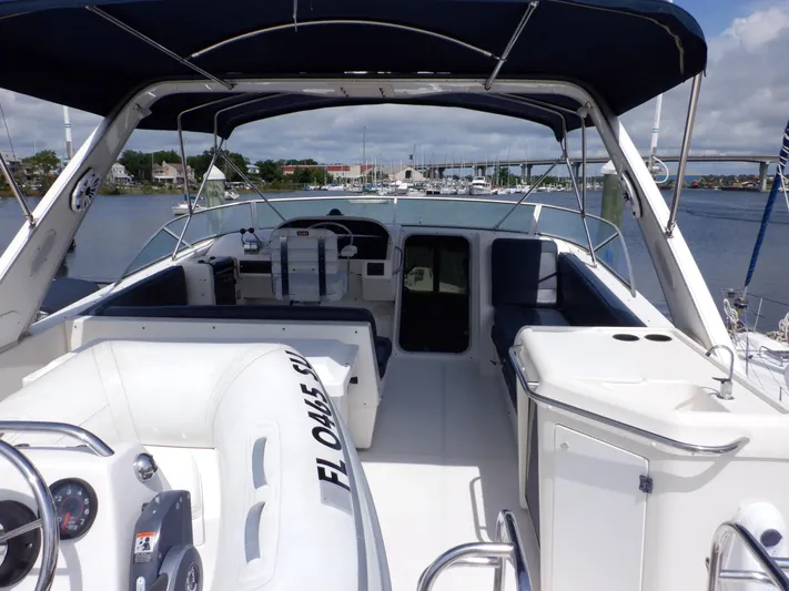 Epic Yacht Photos Pics 1998 Bayliner 4788 Pilothouse Motoryacht interior with seating and helm, docked at marina.