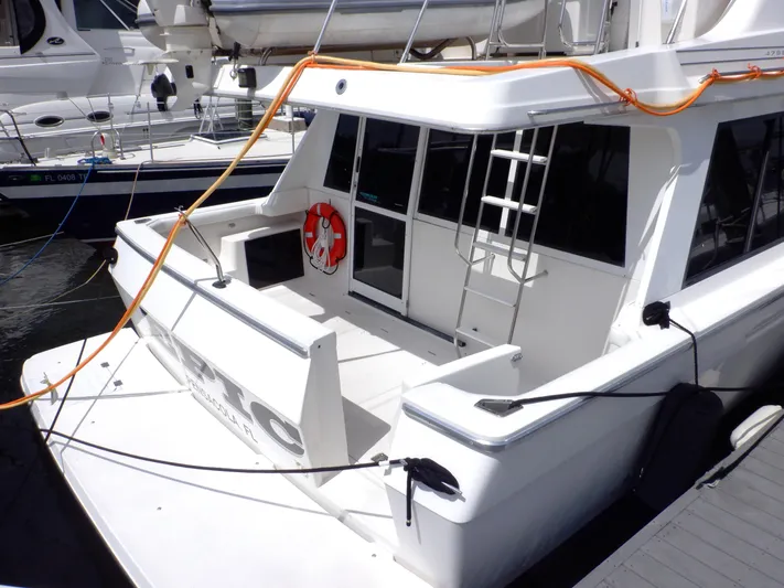 Epic Yacht Photos Pics 1998 Bayliner 4788 Pilothouse Motoryacht docked, featuring spacious deck and safety equipment.