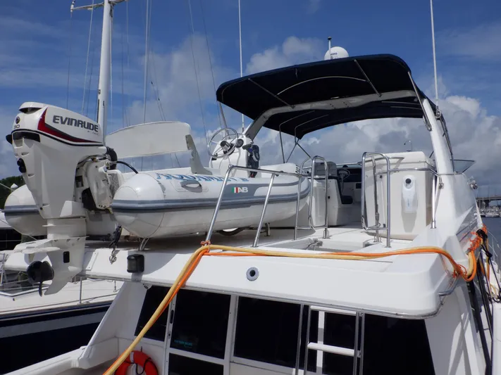 Epic Yacht Photos Pics 1998 Bayliner 4788 Pilothouse Motoryacht with dinghy and Evinrude motor on deck.
