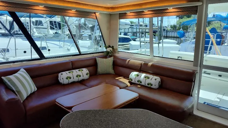 Epic Yacht Photos Pics Luxurious interior of 1998 Bayliner 4788 Pilothouse Motoryacht with leather seating and marina view.