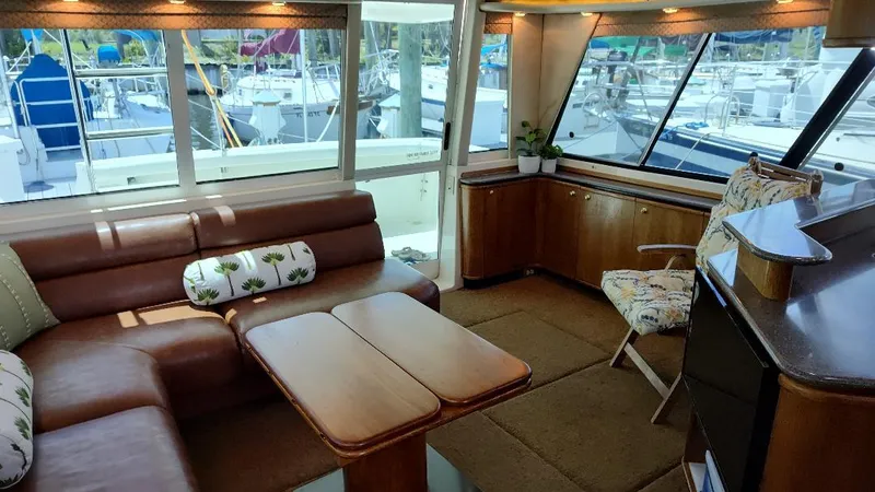 Epic Yacht Photos Pics Luxurious interior of a 1998 Bayliner 4788 Pilothouse Motoryacht with leather seating and large windows.