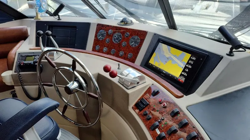 Epic Yacht Photos Pics 1998 Bayliner 4788 Pilothouse Motoryacht helm with steering wheel and navigation controls.