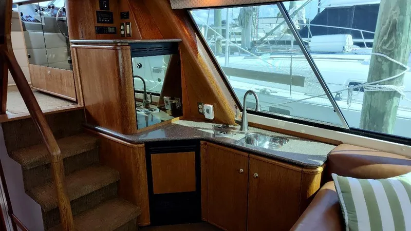 Epic Yacht Photos Pics Interior of 1998 Bayliner 4788 Pilothouse Motoryacht with wood finish and kitchenette.