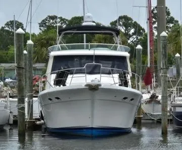 Epic Yacht Photos Pics 1998 Bayliner 4788 Pilothouse Motoryacht docked in a marina.