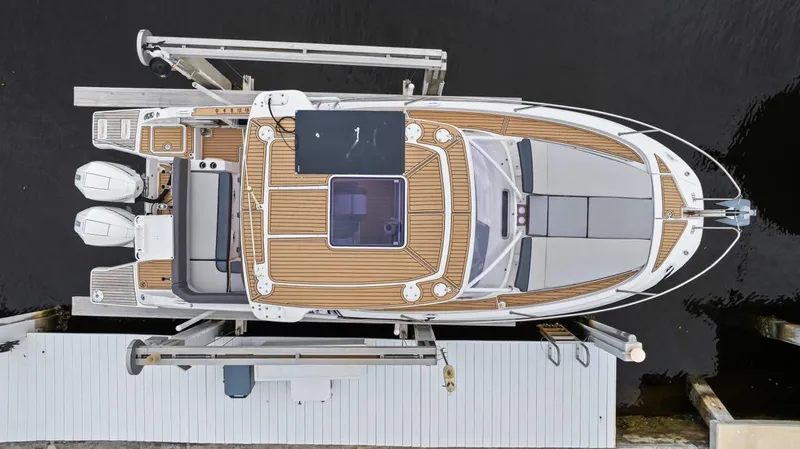  Yacht Photos Pics Aerial view of 2020 Jeanneau Leader 9.0 WA boat docked, showcasing sleek design and twin engines.