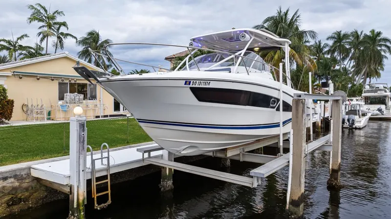  Yacht Photos Pics 2020 Jeanneau Leader 9.0 WA boat docked near waterfront home with palm trees.