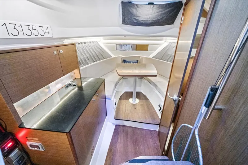  Yacht Photos Pics Interior of 2020 Jeanneau Leader 9.0 WA boat with modern kitchen and seating area.