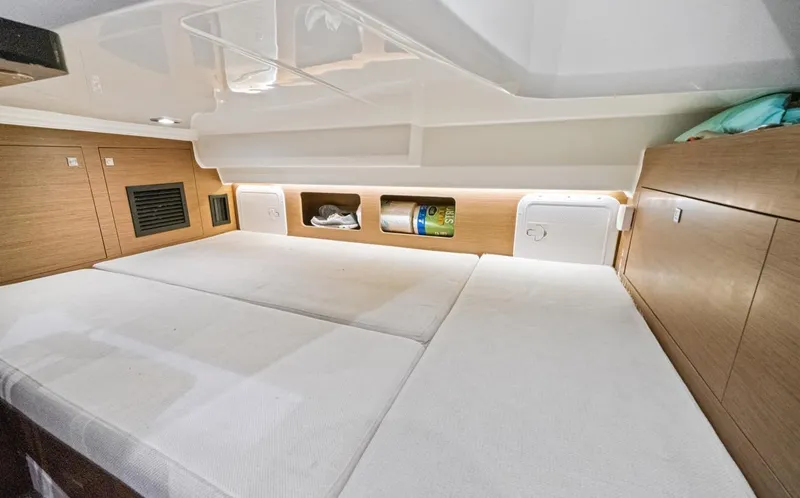  Yacht Photos Pics Interior cabin of 2020 Jeanneau Leader 9.0 WA with cozy bedding and storage.