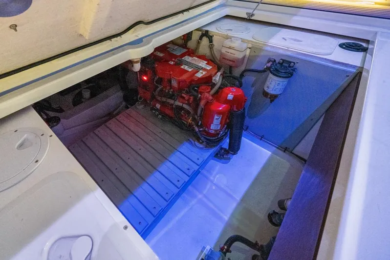  Yacht Photos Pics Engine compartment of 2020 Jeanneau Leader 9.0 WA boat, featuring red engine components.