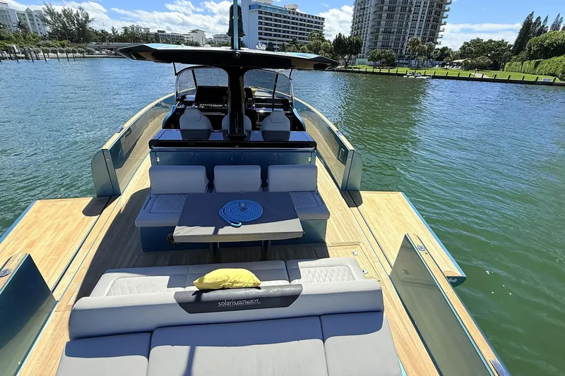  Yacht Photos Pics Luxurious 2022 Solaris Power 44 yacht with spacious deck and modern seating on calm waters.