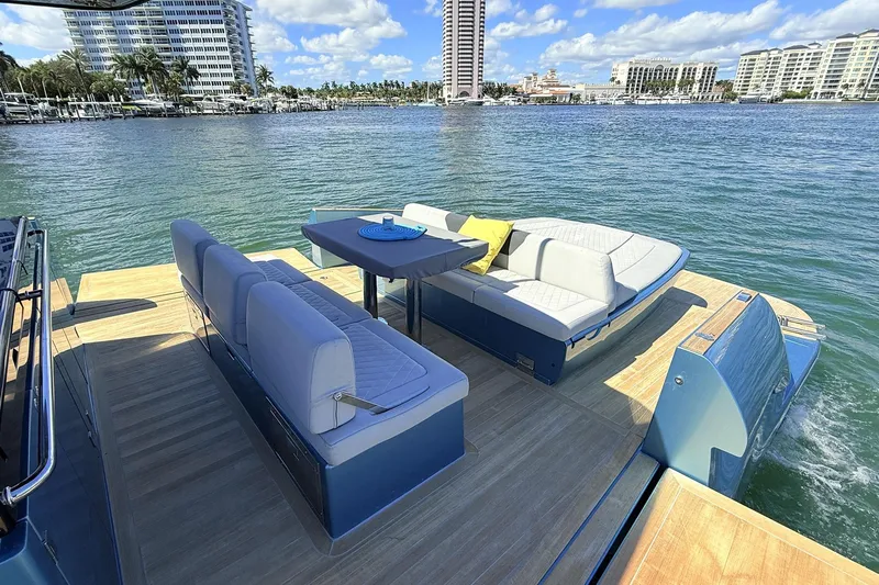  Yacht Photos Pics Luxurious 2022 Solaris Power 44 yacht with elegant seating, cruising on a sunny waterfront.