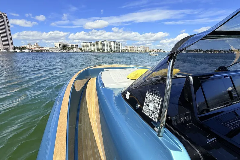  Yacht Photos Pics 2022 Solaris Power 44 yacht cruising on a sunny day with city skyline in background.