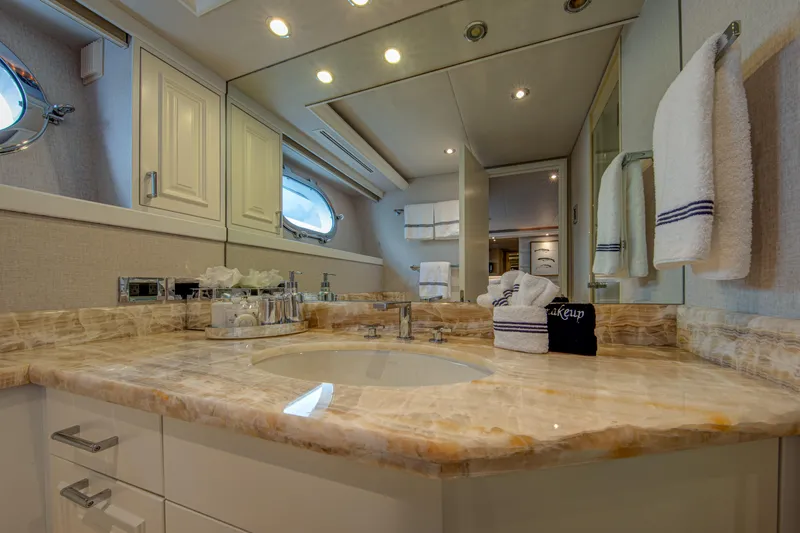 Spirit Yacht Photos Pics Luxurious bathroom in a 2010 Westport 112 yacht with marble countertop and modern fixtures.