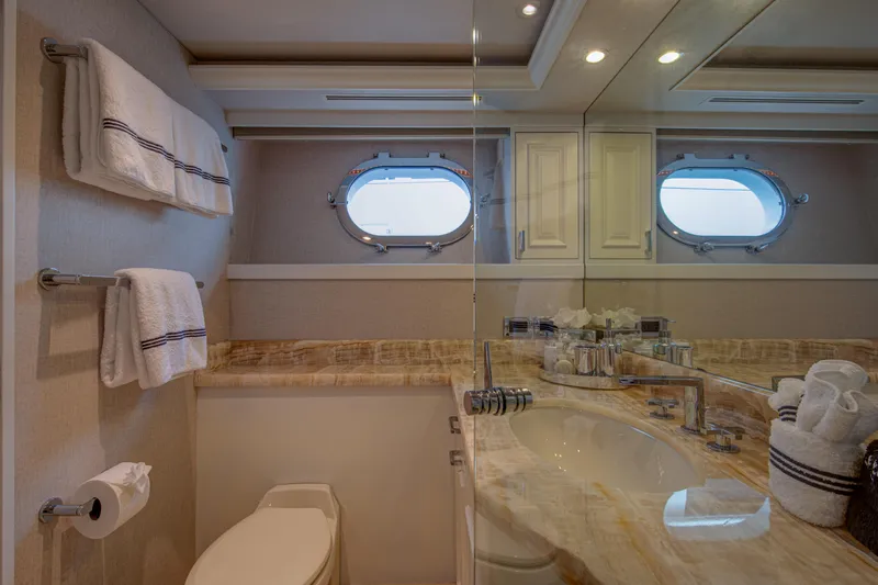 Spirit Yacht Photos Pics Luxurious bathroom on a 2010 Westport 112 yacht with marble countertop and porthole windows.