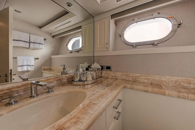 Spirit Yacht Photos Pics Luxurious bathroom in a 2010 Westport 112 yacht with marble countertop and porthole window.