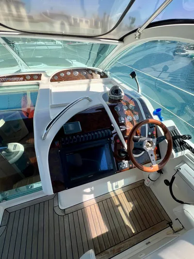  Yacht Photos Pics Cockpit of 1999 Fairline Targa 48 Open yacht with wooden steering wheel and control panel.