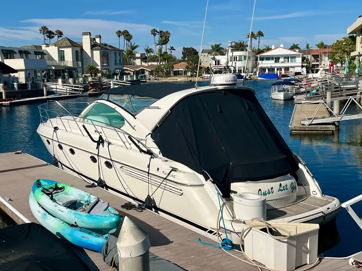  Yacht Photos Pics 1999 Fairline Targa 48 Open yacht docked in a marina, with kayaks nearby.