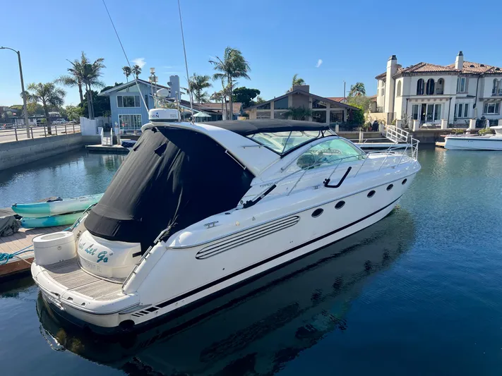  Yacht Photos Pics 1999 Fairline Targa 48 Open yacht docked in a serene marina setting.