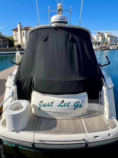  Yacht Photos Pics 1999 Fairline Targa 48 Open yacht docked, rear view with cover, "Just Let Go" text.