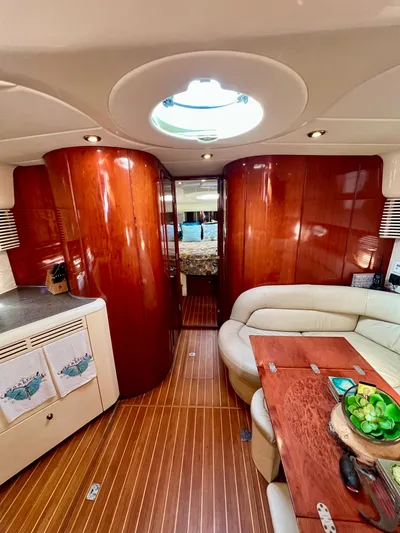  Yacht Photos Pics Interior of 1999 Fairline Targa 48 Open yacht with elegant wood finish and cozy seating.
