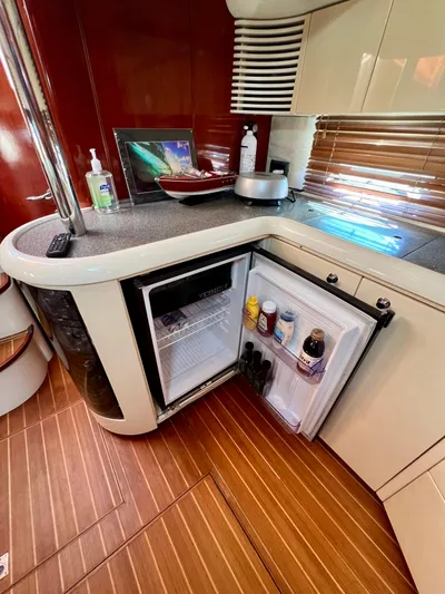  Yacht Photos Pics Compact kitchen area in a 1999 Fairline Targa 48 Open yacht with open mini-fridge.