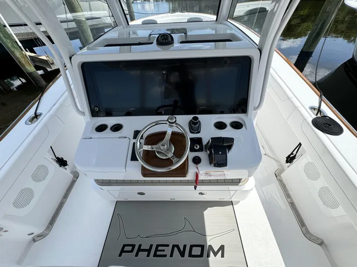  Yacht Photos Pics Cockpit of 2025 Phenom 37 boat with steering wheel and control panel.